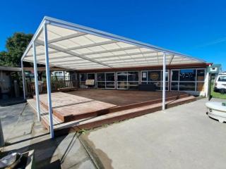 Durable mono-pitch awning designed for outdoor living spaces
