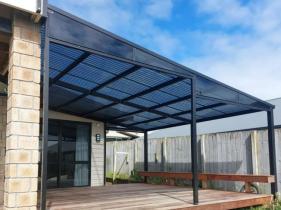 Custom-made mono-pitch awning providing shade over a patio