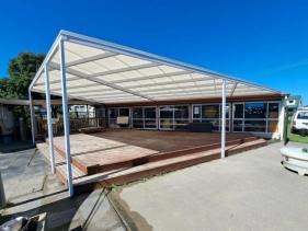 Durable mono-pitch awning designed for outdoor living spaces